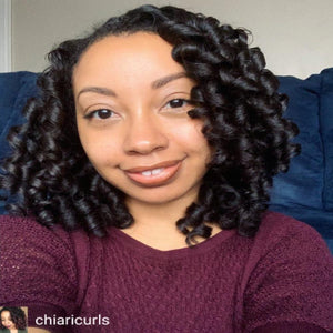 woman with natural hair style with loose curls achieved by using Moisture Hair Kit