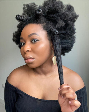 Black woman with 4C natural hair showing hair growth